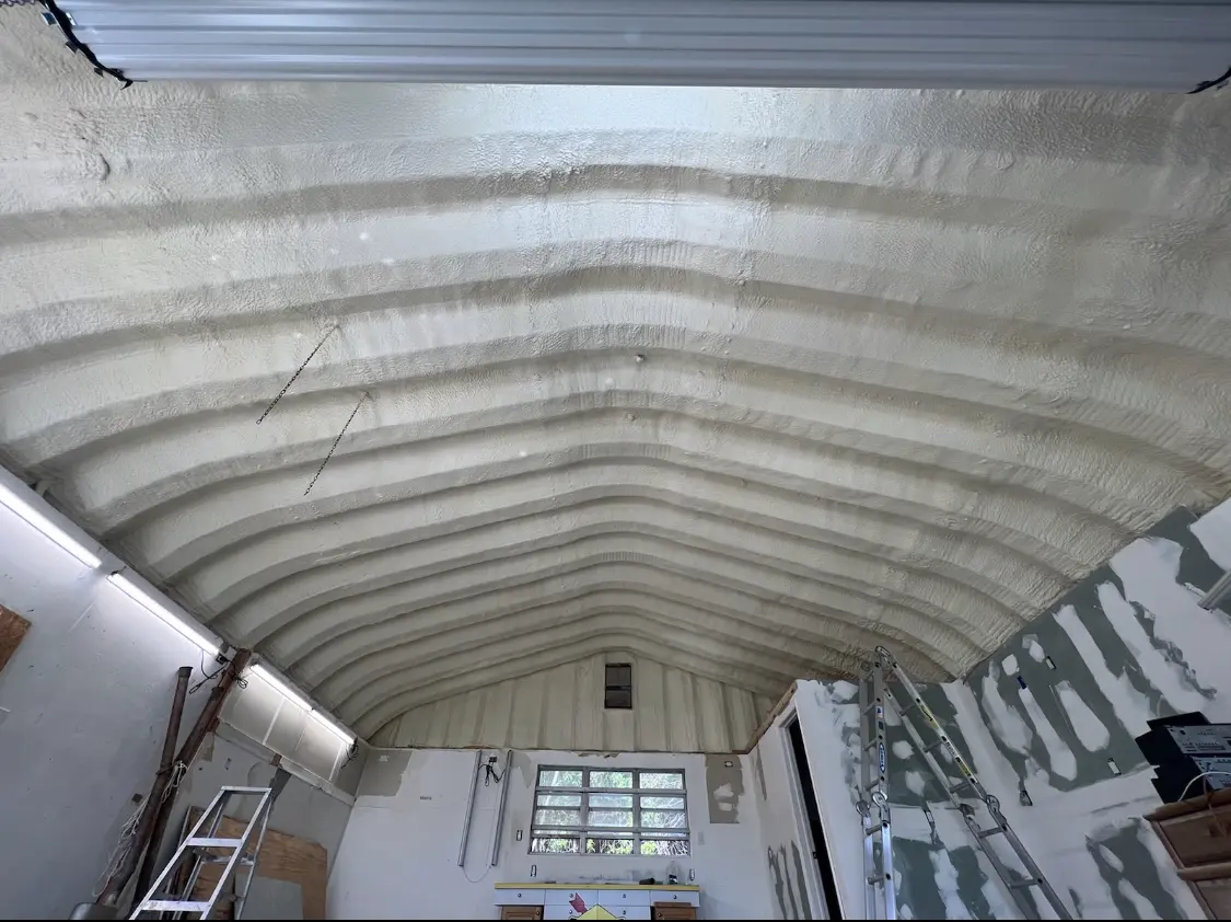 Spray polyurethane foam applied to the underside of a metal roof deck in Enterprise